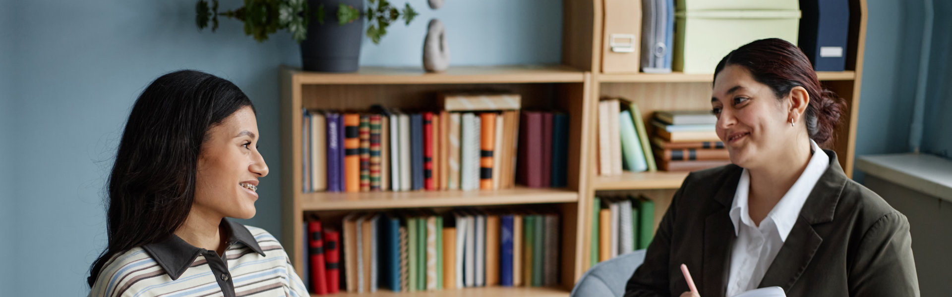 two women smiling at each other