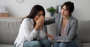 professional woman consoling the depress woman