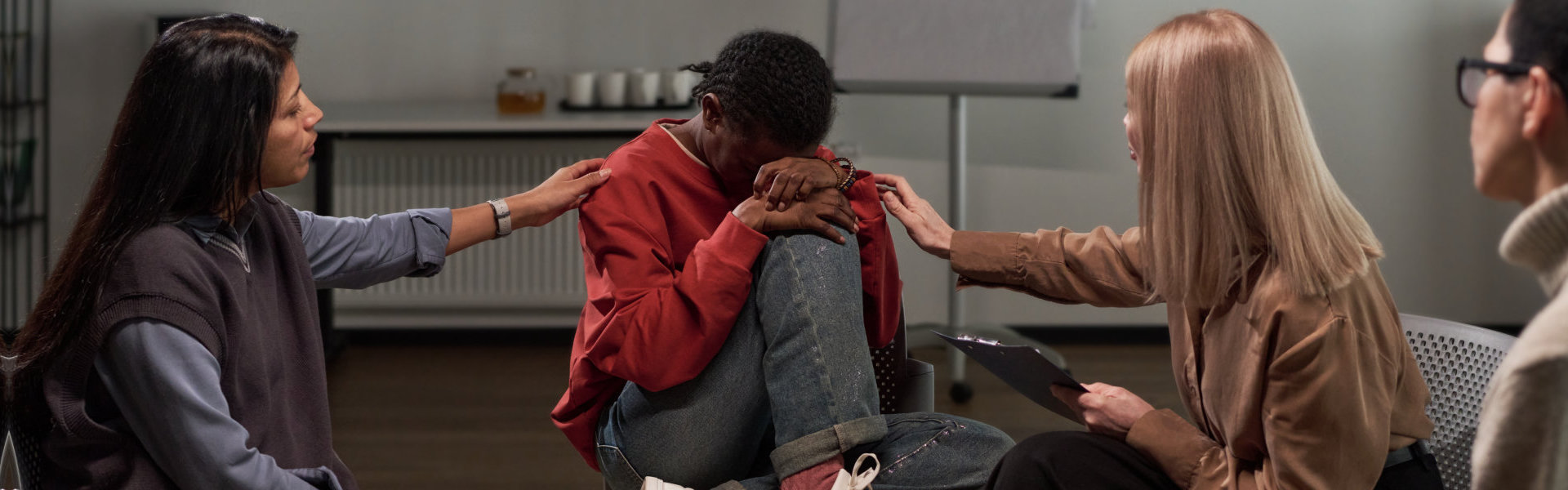 two woman consoling the man